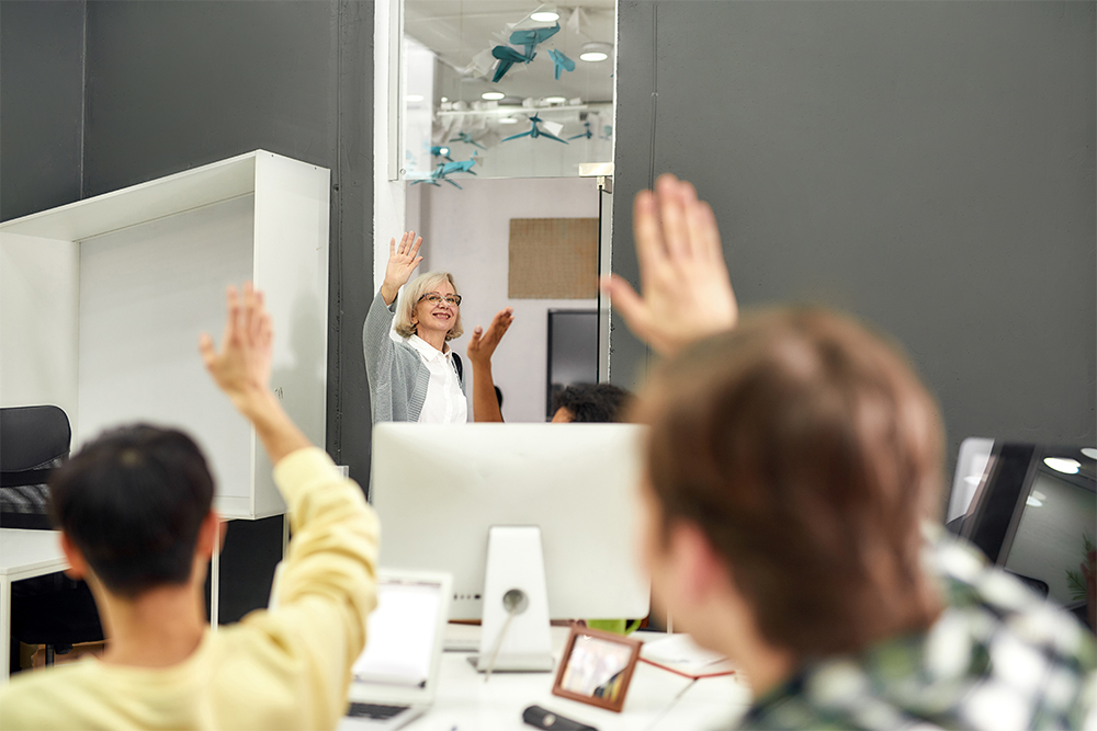 Cheerful aged woman saying goodbye to office colleagues