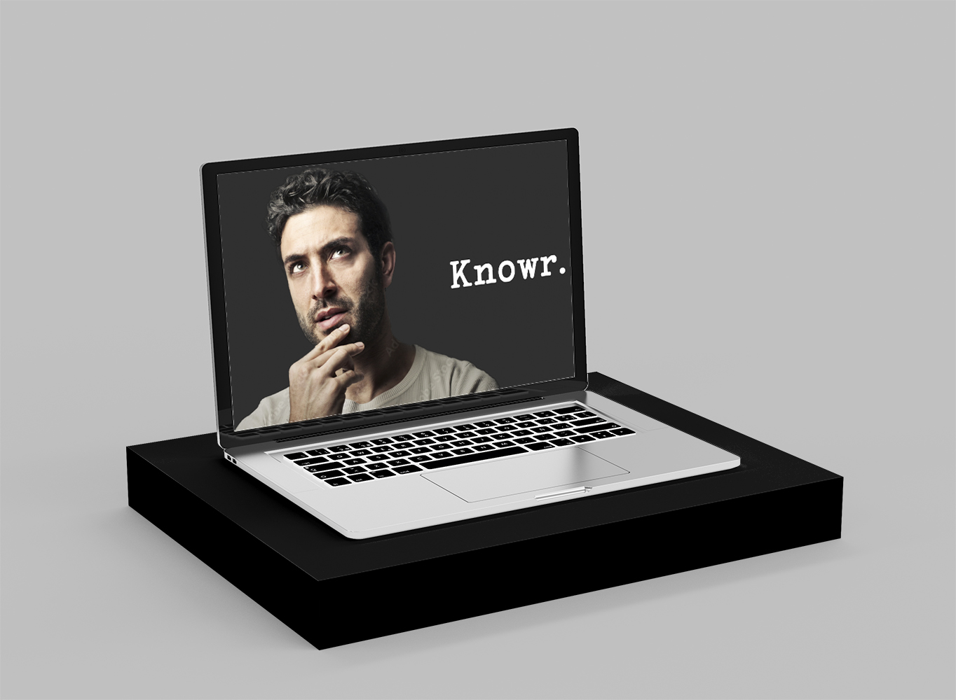 Laptop on stand showing software named Knowr and picture of man thinking.