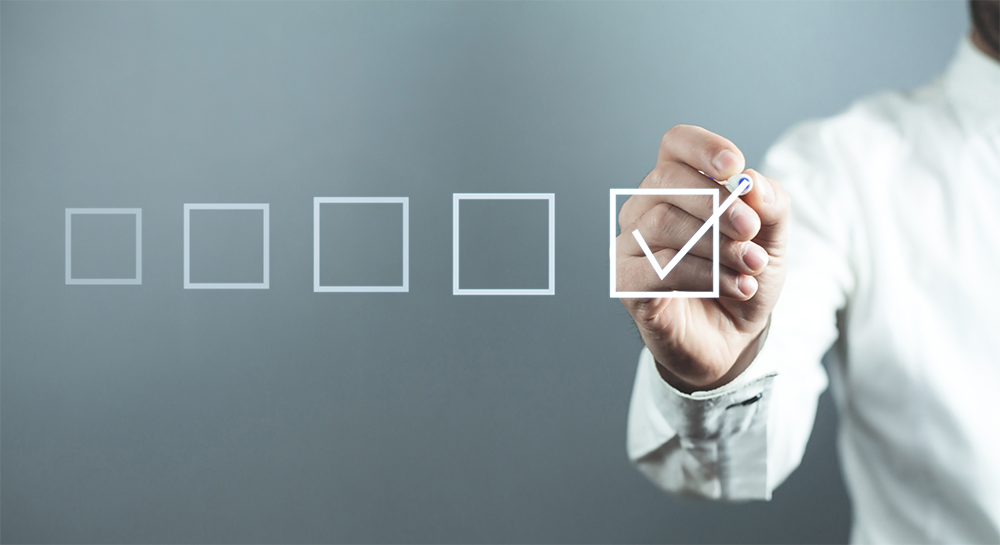 Man checking boxes on transparant wall.