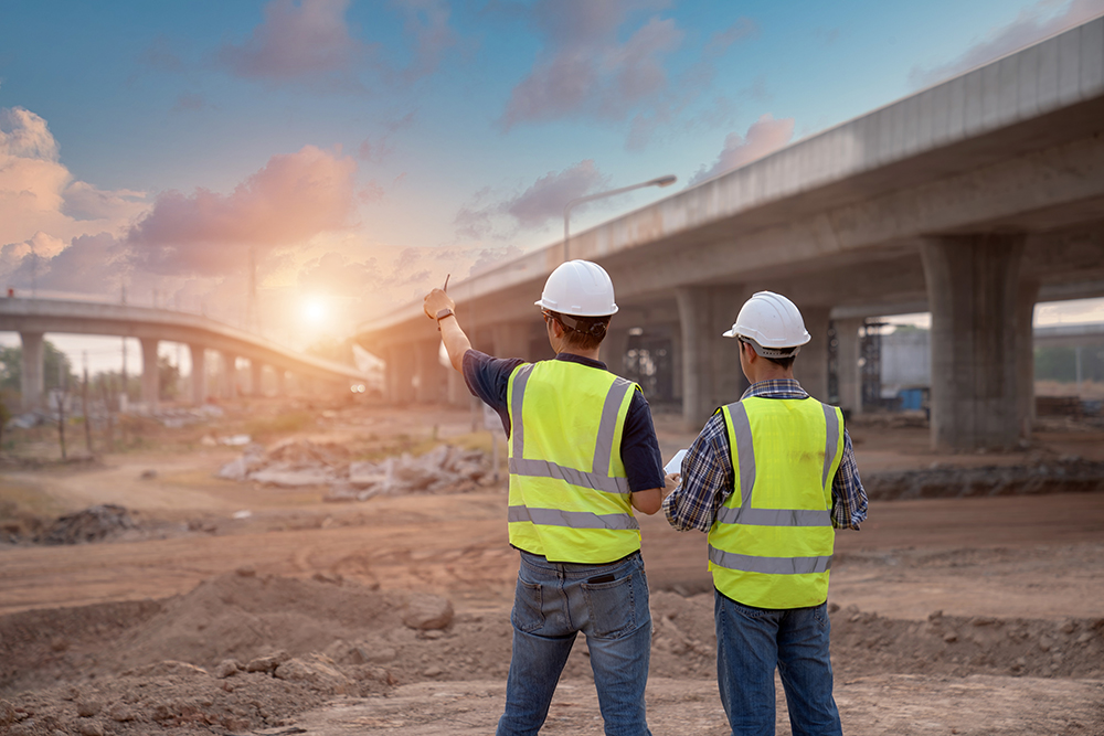 Two contracters discussing roads project.