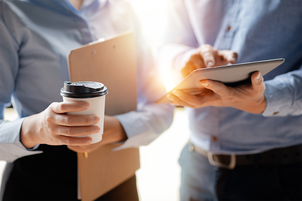 Business man and woman meeting to discuss information over coffee.